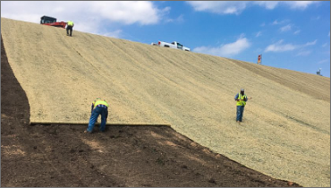 Men placing matting